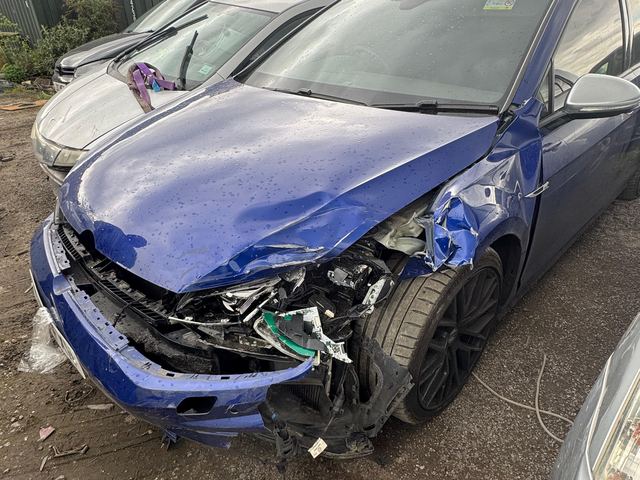 Blue BMW M4 with smashed front bumper, wing and headlight, before repair