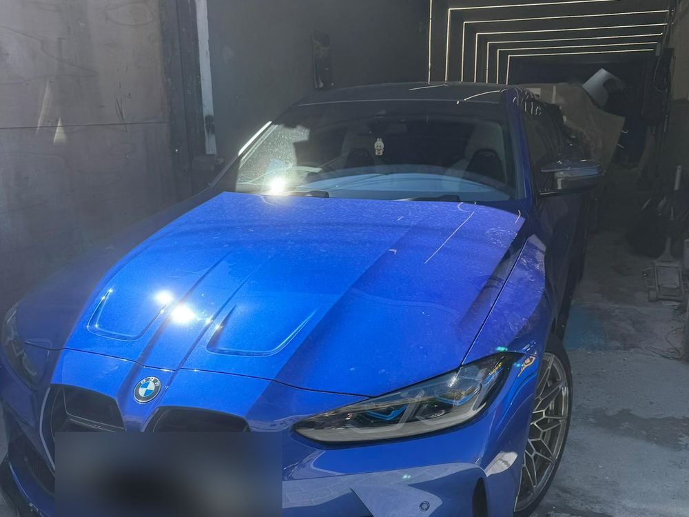 BMW M4 after front-end repair, in the spray booth at E17 Bodyworks